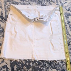 Super cute and clean, distressed mini, white denim skirt.